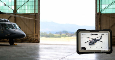 AI predictive maintenance device in front of a military helicopter