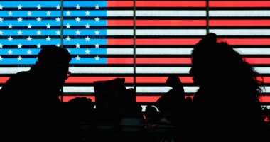 Two US military personnel operating technology