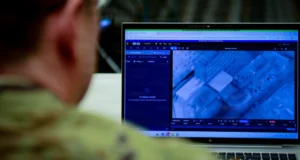 US Army officer views Maven Smart System interface on laptop during training session in Arlington, Virginia. Photo: Master Sgt. Whitney Hughes/DVIDS