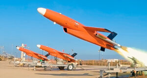 Orange BQM-177A target drone launches from ground rail during Shield AI Hivemind autonomy test.