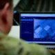U.S. Army officer examining the Maven Smart System interface on a laptop during National Guard Bureau training.
