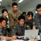 U.S., South Korean, and Japanese personnel collaborate during a planning session at Exercise Cobra Gold, supporting multinational coordination on space and operational technologies.
