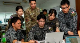 U.S., South Korean, and Japanese personnel collaborate during a planning session at Exercise Cobra Gold, supporting multinational coordination on space and operational technologies.