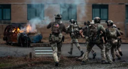 US Special Operations Forces soldiers conduct a breaching operation during a training exercise in an urban environment.