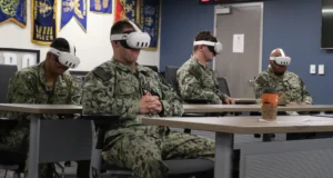 U.S. Navy personnel wearing VR headsets during immersive training using AI-driven simulation technology. Photo: Petty Officer 1st Class Josh Cote/DVIDS