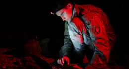 A student assigned to the U.S. Army John F. Kennedy Special Warfare Center and School, who is in the Special Forces Communications Sergeant course, uses a PDA-184 computer during nighttime antenna training at Fort Bragg, North Carolina August 30, 2019. The training qualified students in the high frequency communications module which trained them to be proficient in making, installing, operating and maintaining short-, medium-, and long-range antennas in order to communicate at long distances. (U.S. Army photo by K. Kassens)