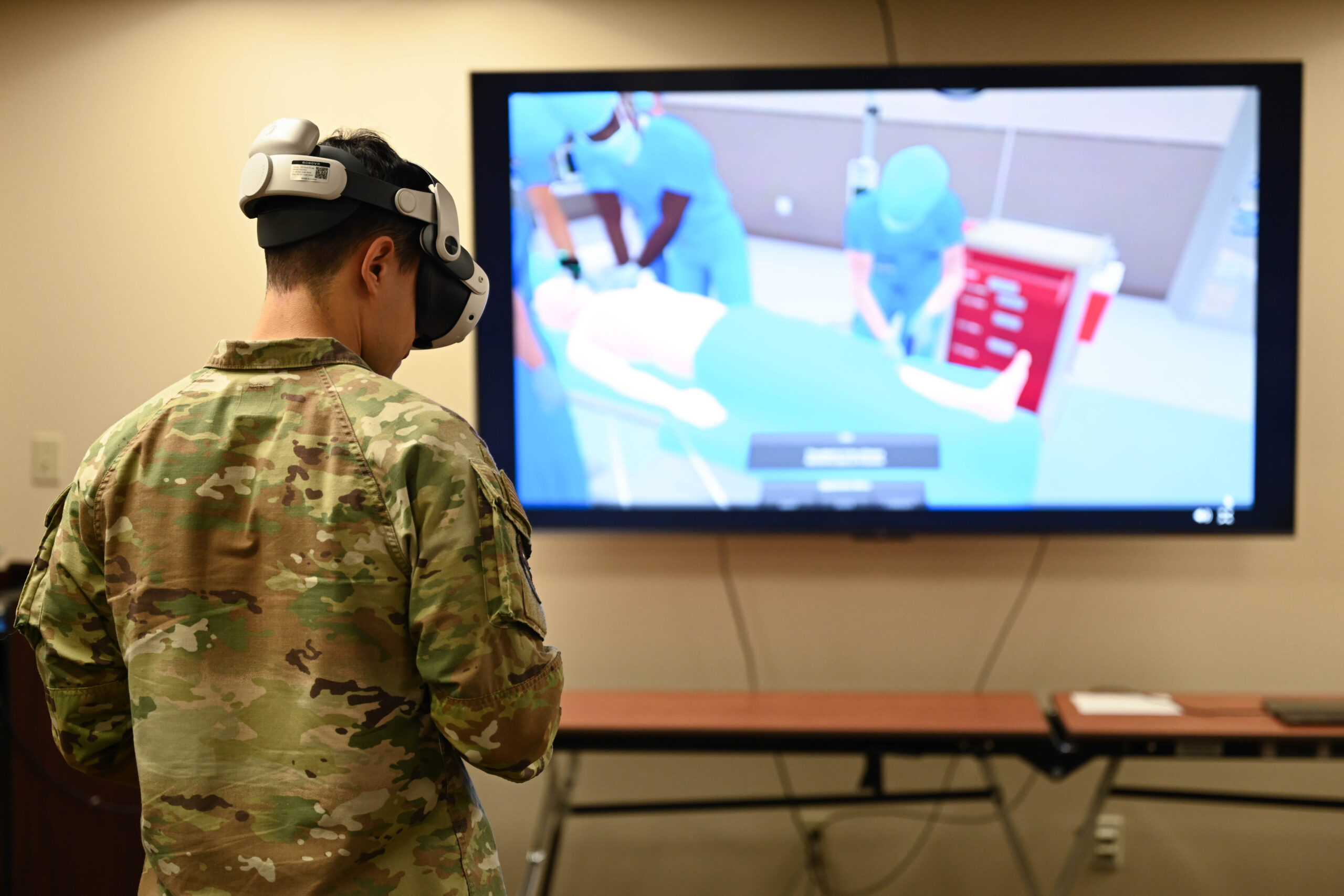 U.S. Air Force Senior Airman Martin Gamez Corral, 28th Health Care Operations Squadron ambulance services medical technician, operates a virtual reality simulator at Ellsworth Air Force Base, S.D., Oct. 30, 2025. This VR system allows Airmen to train for simulated specific healthcare situations. (U.S. Air Force Photo by Airman 1st Class Addison Bolt)