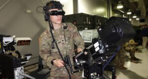 US Army soldier wearing a headset operates a virtual training simulator as part of the Synthetic Training Environment program. Photo: Michael Novogradac/US Army