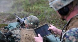 US troops using a tablet-based communication system.