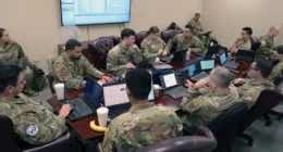Anthropic vs Pentagon | US servicemembers in uniform use laptops during a cybersecurity assessment in a government facility.