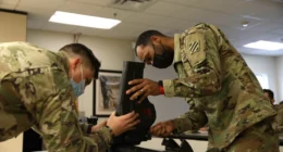 U.S. Army soldiers assembling and maintaining military equipment on a workbench, illustrating AI-assistant support