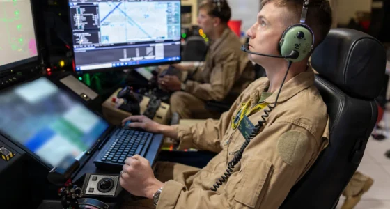 U.S. Marine Corps drone operators monitoring multiple screens at a control station for ISR and targeting operations