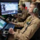 U.S. Marine Corps drone operators monitoring multiple screens at a control station for ISR and targeting operations