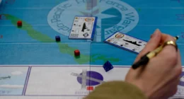 US Air Force wargaming board with tokens and scenario cards used in training exercise for operational planning and decision-making