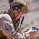 U.S. Marine operating a handheld device in a field training environment