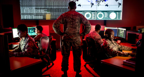 Capt. Taiwan Veney, cyber warfare operations officer, watches members of the 175th Cyberspace Operations Group, from left, Capt. Adelia McClain, Staff Sgt. Wendell Myler, Senior Airman Paul Pearson and Staff Sgt. Thacious Freeman, analyze log files and provide a cyber threat update utilizing a Kibana visualization on the large data wall in the Hunter's Den at Warfield Air National Guard Base, Middle River, Md., June 3, 2017. (U.S. Air Force photo by J.M. Eddins Jr.)