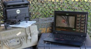 Edge AI system analyzing drone footage for real-time threat detection on a rugged military laptop