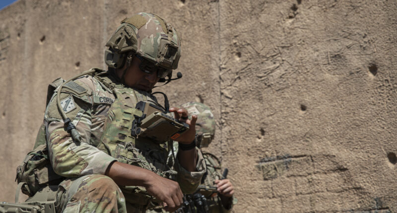 Staff Sgt. Victor Corena, assigned to Assault Company, 1st Battalion, 8th Infantry Regiment, 3rd Armored Brigade Combat Team, 4th Infantry Division, checks operational data on his end-user device during a field training exercise that demonstrates Next Generation Command and Control AN/PRC-166 radio technology on Fort Carson, Colorado, on September 18, 2025. The NGC2 ecosystem integrates software applications, infrastructure, data, and transport into a unified operational architecture, providing commanders with real-time information to make more, better and faster decisions. (U.S. Army photo by Sgt. William Rogers)