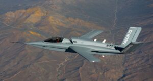 Northrop Grumman's Talon IQ aircraft in flight over desert terrain during AI autonomy handover test