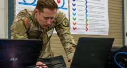 Scale AI | US Army cyber specialist working on laptops during a military cyber defense exercise.