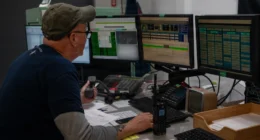 Military and contractor personnel oversee digital operations and satellite-linked mission systems during space operations support activities.
