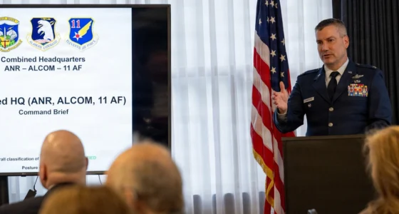 A US Air Force officer delivers a headquarters briefing during an Eleventh Air Force event.