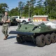 A US Marine Corps service member operates expeditionary logistics equipment during field testing. The Marine Corps is expanding AI-enabled sustainment and battlefield networking capabilities through Project Dynamis.