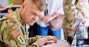 US Army soldier using a laptop during a training exercise at Fort Sill, Oklahoma.