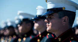 US Marines in dress uniform standing in formation during a ceremonial event.