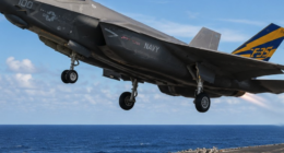 A US Navy F-35C launches from an aircraft carrier during flight operations.