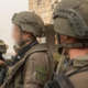 Israeli soldiers coordinate during a field operation.