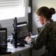 A robotics warfare specialist plots the path of a global autonomous reconnaissance craft during a live fire exercise