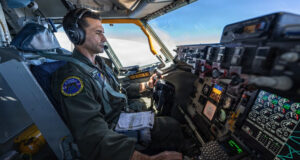 A US Air Force aircrew member operates mission systems aboard a military aircraft. Photo: Airman 1st Class Arnet Tamayo/DVIDS
