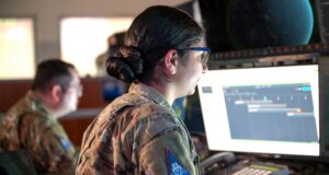 Military members man computer workstations