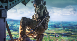 A US Army soldier aboard a helicopter overlooking a digitally enhanced battlefield representing artificial intelligence-enabled operations. Image: Everforth ECS
