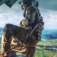 A US Army soldier aboard a helicopter overlooking a digitally enhanced battlefield representing artificial intelligence-enabled operations. Image: Everforth ECS