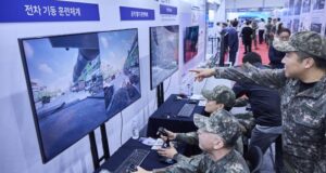 South Korean soldiers interact with battlefield simulation technology showcased by SK Telecom.
