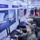 South Korean soldiers interact with battlefield simulation technology showcased by SK Telecom.